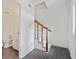 Hallway with gray tile floor, stairway with wood railing, leading to bathroom at 5 Palace Green Place Nw, Atlanta, GA 30318