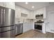 Modern kitchen features stainless steel appliances, white cabinets, and plank flooring at 5 Palace Green Place Nw, Atlanta, GA 30318