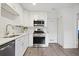Bright kitchen with white cabinets, stainless steel appliances, and wood-look floors at 5 Palace Green Place Nw, Atlanta, GA 30318