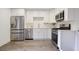 Modern kitchen features stainless steel appliances, white cabinets, and plank flooring at 5 Palace Green Place Nw, Atlanta, GA 30318