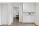 Bright white pantry with built-in cabinets and plank flooring at 5 Palace Green Place Nw, Atlanta, GA 30318