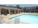 Inviting community pool with covered patio, lounge chairs and well-maintained landscaping at 5 Palace Green Place Nw, Atlanta, GA 30318