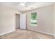 Cozy bedroom with neutral walls, plush carpet, and a window view at 60 Cypress Dr, Covington, GA 30016