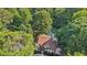 Overhead shot of a home with pool surrounded by dense trees offering seclusion and privacy at 205 Pine Lake Dr, Cumming, GA 30040