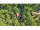 Aerial view of a single Gathering home surrounded by mature trees and a pool at 205 Pine Lake Dr, Cumming, GA 30040