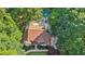 Aerial view of a home, showcasing a pool, patio area, and lush green surroundings at 205 Pine Lake Dr, Cumming, GA 30040