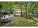 Lush backyard with an outdoor patio, pool area, and tree coverage creating a beautiful outdoor retreat at 205 Pine Lake Dr, Cumming, GA 30040