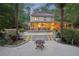 An entertainer's backyard featuring an expansive back porch, deck, and patio with stone fire pit perfect for gatherings at 205 Pine Lake Dr, Cumming, GA 30040