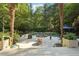 Expansive backyard patio featuring ample seating, lush greenery, and a tranquil pool area, ideal for outdoor gatherings at 205 Pine Lake Dr, Cumming, GA 30040