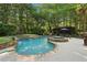 Lush backyard pool area with a serene waterfall feature and comfortable seating arrangements, perfect for relaxation at 205 Pine Lake Dr, Cumming, GA 30040
