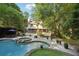 Serene backyard showcasing a stunning pool, spa, and an inviting patio area perfect for relaxation and outdoor entertainment at 205 Pine Lake Dr, Cumming, GA 30040