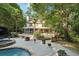 Inviting backyard featuring a well-maintained patio, lush greenery, and direct access to the home's outdoor deck at 205 Pine Lake Dr, Cumming, GA 30040