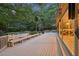 Spacious deck with seating overlooking a lush backyard with landscaping and swimming pool at 205 Pine Lake Dr, Cumming, GA 30040