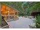 A screened-in porch with a white deck and seating overlooking the lush, private backyard at 205 Pine Lake Dr, Cumming, GA 30040