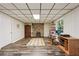 Spacious finished basement with a stone fireplace, creating a cozy and inviting atmosphere at 205 Pine Lake Dr, Cumming, GA 30040