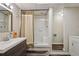 Bathroom featuring a walk-in shower, wood-look vinyl flooring, and vanity with wood accents at 205 Pine Lake Dr, Cumming, GA 30040