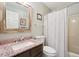 Bathroom featuring a vanity with marble countertops, toilet, and bathtub with shower at 205 Pine Lake Dr, Cumming, GA 30040