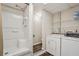 Bathroom featuring a walk-in shower, laundry, and wire rack shelves for extra storage at 205 Pine Lake Dr, Cumming, GA 30040