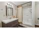 Bathroom featuring a walk-in shower and a vanity with wood accents and modern fixtures at 205 Pine Lake Dr, Cumming, GA 30040