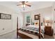 Bright bedroom featuring a ceiling fan, double closets, and a view to the backyard at 205 Pine Lake Dr, Cumming, GA 30040