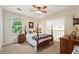 Inviting bedroom with a four-poster bed, neutral carpet and natural light at 205 Pine Lake Dr, Cumming, GA 30040
