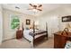 Comfortable bedroom featuring a four-poster bed, large window, and neutral decor at 205 Pine Lake Dr, Cumming, GA 30040