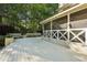 Large wooden deck featuring an attached screened-in porch with benches for backyard enjoyment at 205 Pine Lake Dr, Cumming, GA 30040