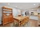 Dining room includes a wooden table, hardwood floors, and views into the kitchen area at 205 Pine Lake Dr, Cumming, GA 30040