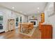 A dining room featuring hardwood floors, double doors to a patio, and a white brick fireplace at 205 Pine Lake Dr, Cumming, GA 30040