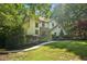 Well-manicured front lawn and mature trees surrounding this charming two-story home at 205 Pine Lake Dr, Cumming, GA 30040