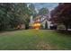 Charming, two-story home with a brick chimney and lush landscaping, all nestled among mature trees at 205 Pine Lake Dr, Cumming, GA 30040