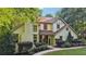 Lovely two-story home with a brick facade, well-maintained landscaping, and a paved walkway at 205 Pine Lake Dr, Cumming, GA 30040