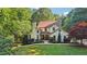 Beautiful two-story home with a brick facade, a manicured lawn, and mature trees at 205 Pine Lake Dr, Cumming, GA 30040