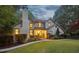 Charming, two-story home with a brick chimney, lush landscaping, and stone walkway at 205 Pine Lake Dr, Cumming, GA 30040