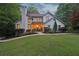 Charming, two-story home with a brick chimney, lush landscaping, and inviting entryway at 205 Pine Lake Dr, Cumming, GA 30040