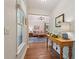 Hallway with hardwood floors that leads into a living room with a chandelier at 205 Pine Lake Dr, Cumming, GA 30040