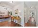 Hallway with hardwood floors that leads into a living room with a chandelier at 205 Pine Lake Dr, Cumming, GA 30040