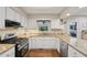 Well-lit kitchen featuring granite countertops, stainless steel appliances, and hardwood floors at 205 Pine Lake Dr, Cumming, GA 30040