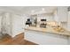 Bright kitchen with white cabinets, granite countertops, stainless steel appliances and hardwood flooring at 205 Pine Lake Dr, Cumming, GA 30040