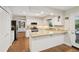 Well-lit kitchen features granite countertops, stainless steel appliances, and hardwood floors at 205 Pine Lake Dr, Cumming, GA 30040