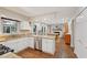 Open-concept kitchen with white cabinets, granite countertops, and hardwood floors flowing into the dining area at 205 Pine Lake Dr, Cumming, GA 30040