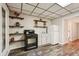 Basement kitchenette with a stove, sink, and floating shelves at 205 Pine Lake Dr, Cumming, GA 30040