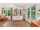 Living room with a built-in shelf, hardwood floors, a window, and double doors to a patio at 205 Pine Lake Dr, Cumming, GA 30040