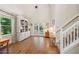 Living room featuring hardwood floors, built-in shelving and storage, and double doors to a patio at 205 Pine Lake Dr, Cumming, GA 30040