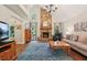 Comfortable living room with stone fireplace, hardwood floors and bright windows at 205 Pine Lake Dr, Cumming, GA 30040