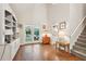 Living room featuring hardwood floors, built-in shelving and storage, and double doors to a patio at 205 Pine Lake Dr, Cumming, GA 30040