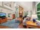 Spacious living room with a stone fireplace and large windows at 205 Pine Lake Dr, Cumming, GA 30040