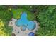 Aerial view of a kidney-shaped pool with a spa, surrounded by a concrete patio at 205 Pine Lake Dr, Cumming, GA 30040