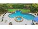 Kidney-shaped pool with a hot tub and waterfall feature with patio furniture at 205 Pine Lake Dr, Cumming, GA 30040