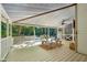 Covered porch overlooking a backyard area featuring benches, table set, and a ceiling fan at 205 Pine Lake Dr, Cumming, GA 30040